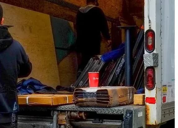 Boxes and furniture being loaded into a moving truck