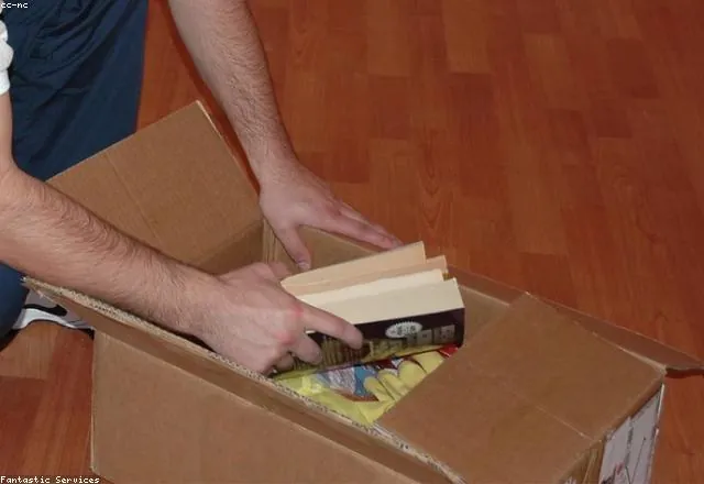 Packing belongings into labelled moving boxes